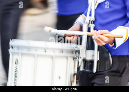 Motion blur snare drummer in blue and white uniform  playing drum in a march Stock Photo