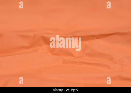 orange creased color paper texture background selective focus closeup Stock Photo