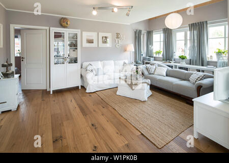 Modern Nordic Living room in family house with white and gray furniture and wooden floor, Korbach, Hesse, Germany, Europe Stock Photo
