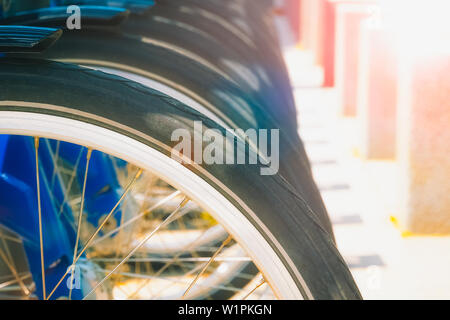Row of wheels of parked bicycles or bikes with sun flares and copy space. Stock Photo