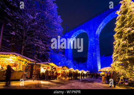 Snowy Christmas market under a railway viaduct, illuminated, Ravennaschlucht, Höllental near Freiburg im Breisgau, Black Forest, Baden-Württemberg, Ge Stock Photo