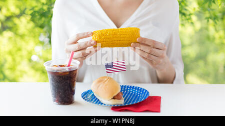 woman hands holding corn with hot dog and cola Stock Photo