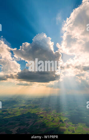 a towering cloud covers up the sun and so creates a dramatic cue state, Bavaria, Germany Stock Photo