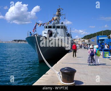 Split, Croatia - April 27, 2019. Croatian military exhibition. Tourist posing in front of Navy ship Vukovar anchored in harbor Stock Photo