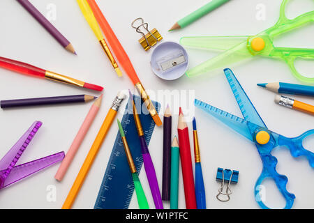 Art supplies background with paintbrushes, scissors and pencils Stock Photo