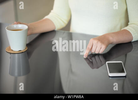 woman with coffee using black interactive panel Stock Photo