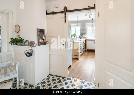 Entryway of modern Nordic Interior family house with white and gray furniture and antique tiled floor, Korbach, Hesse, Germany, Europe Stock Photo