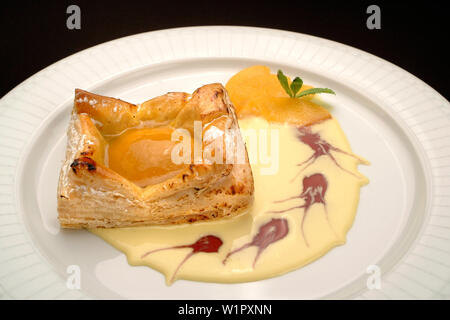 Italian food recipe, traditional  dessert Sfogliatella with peach and egg cream Stock Photo