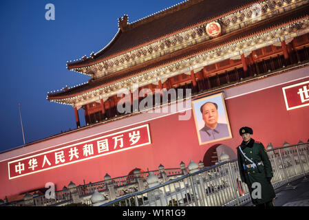 policeman or guard in front of portrait of Mao Zedong at Tiananmen Gate which is the gate to the Forbidden City, Beijing, China, Asia Stock Photo