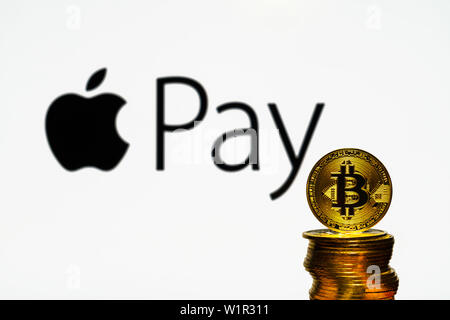 Gold Bitcoin coins with the Apple logo on background screen. A new type of business finance concept Stock Photo