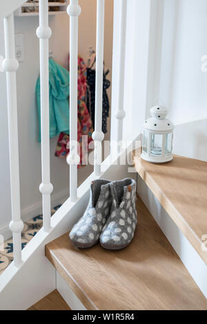Staircase with slippers in family house with wooden steps and white railing, Korbach, Hesse, Germany, Europe Stock Photo