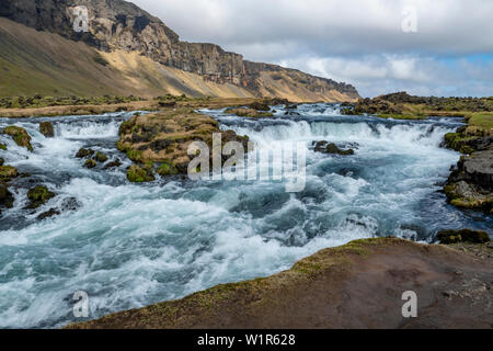 Raging river, waterfalls and rugged landscape on the southeastern coast of Iceland in the late springtime. Stock Photo