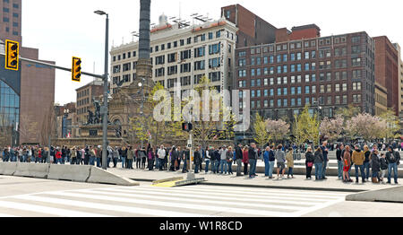 Visitors stand in cool April weather on Public Square in Cleveland, Ohio, USA to visit the Soldiers and Sailors Monument. Stock Photo