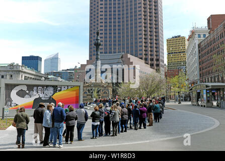 Visitors stand in cool April weather on Public Square in Cleveland, Ohio, USA to visit the Soldiers and Sailors Monument. Stock Photo