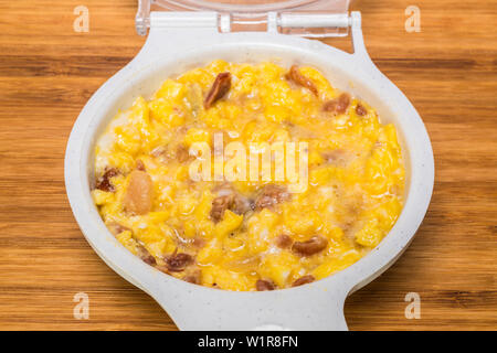 microwave scrambled eggs with ham bacon Stock Photo