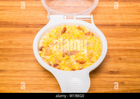 microwave scrambled eggs with ham bacon Stock Photo