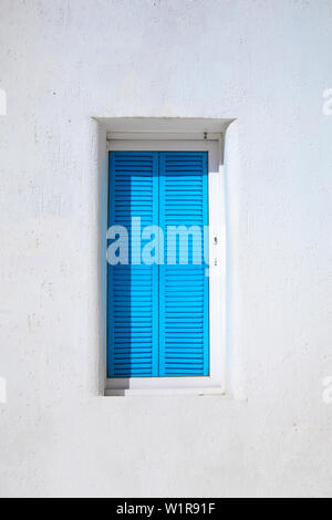 Traditional Aegean style old white house and wall, colorful streets and greek blue window in Bodrum city of Turkey. White colored traditional architec Stock Photo