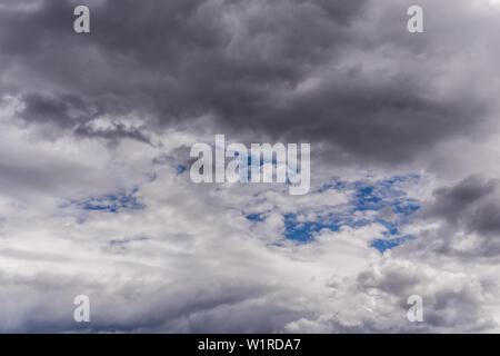 gray incoming near storm clouds daylight backdrop. Stock Photo