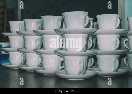 Coffee cups with saucers in stacks Stock Photo
