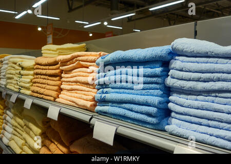 Stacks of folded towels on the shelf in the store. Stock Photo