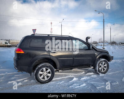 Moscow, Russia - March 24, 2019: Black Mitsubishi Pajero Sport in winter weather Внедорожник Митсубиси Паджеро спорт припаркован зимой на снегу Stock Photo