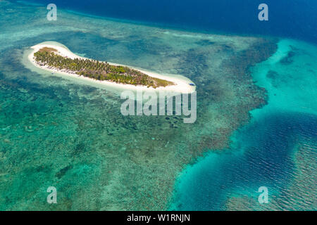 Tropical island Canimeran with sandy beach in the blue sea with coral reef, top view. Balabac, Palawan, Philippines. Small island with palm trees and white sand. Stock Photo