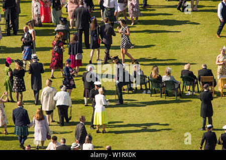 Edinburgh, UK. 3 July 2019.  Her Majesty The Queen has hosted her annual garden party at The Palace of Holyroodhouse in Edinburgh during Royal Week in Scotland.  Her Majesty The Queen's Garden Party was attended by people from all backgrounds and walks of life.  The sun made a fantastic appearance and the band played upbeat music and some covers of well known numbers.  Guests enjoyed afternoon tea with gourmet sandwiches, cakes and royal chocolates. Credit: Colin Fisher/Alamy Live News Stock Photo