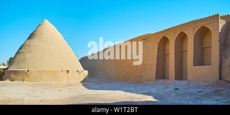 Panorama of the ancient city landmarks - pyramid of yakhchal (ice chamber) and adobe wall of Ghal'eh Jalali fortress, Kashan, Iran Stock Photo