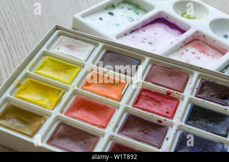 Creative artistic education concept - the box with the set of colorful watercolor paint close up