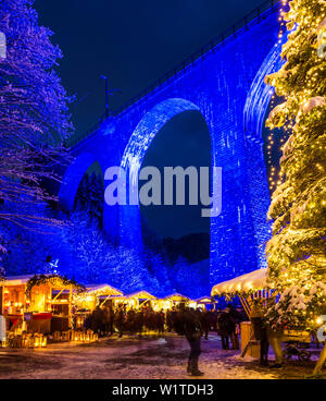 Snowy Christmas market under a railway viaduct, illuminated, Ravennaschlucht, Höllental near Freiburg im Breisgau, Black Forest, Baden-Württemberg, Ge Stock Photo