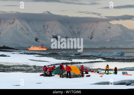 Passengers of expedition cruise ship MS Bremen (Hapag-Lloyd Cruises) set up their overnight camp on a flat stretch of well-packed snow, near Port Lock Stock Photo