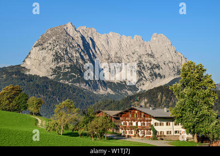 Farm with Wilder Kaiser in the background, from behind a mountain, Wilder Kaiser, Kaiser mountains, Tyrol, Austria Stock Photo