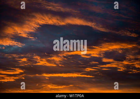 Sunset with red illuminated clouds Stock Photo
