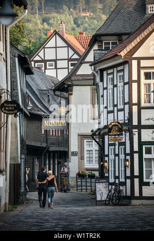 UNESCO World Heritage historic old town of Goslar, couple in love strolling through small alleys of the old town, Harz mountains, Lower Saxony, German Stock Photo