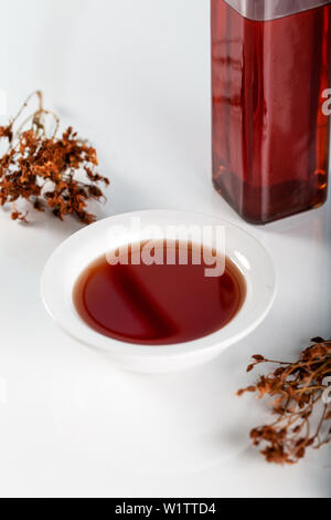 Mixed Herbal Oil with fresh, flowering st. John's wort with dried flowers Stock Photo