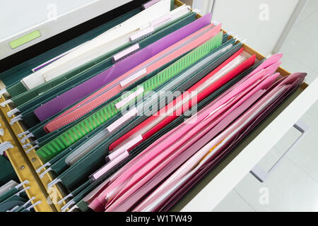 Files document of hanging file folders in a drawer in a whole pile of full papers, at work office, Business Concept Office document storage Stock Photo
