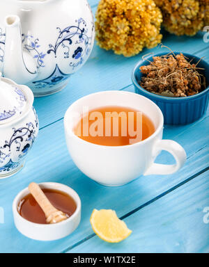 Cup of Linden Tea, Dried Linden Flowers in Cup with honey and lemon on wooden background. Stock Photo