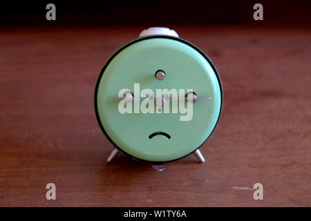 Old mechanical alarm clock on a wooden table. Stock Photo