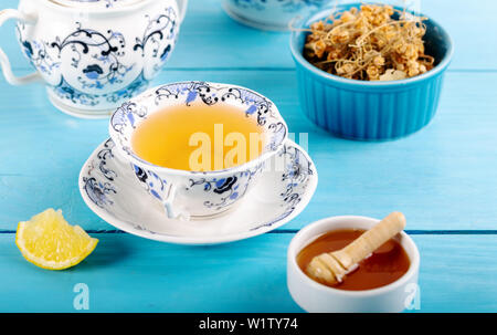 Cup of Linden Tea, Dried Linden Flowers in bowl with honey and lemon on wooden background Stock Photo