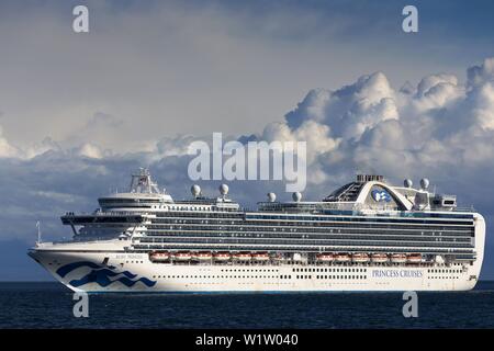Princess Cruises Big White Luxury Cruise Ship Sailing in Strait of Juan De Fuca with dramatic sky background off the Vancouver Island Coast BC Canada Stock Photo