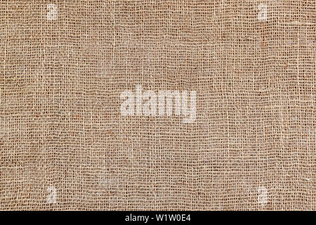 Rural texture of sackcloth. Background of very coarse, rough fabric woven made of flax, jute or hemp. Burlap bag material. Design element. Stock Photo