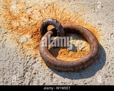 rusting metal ring for fixing small fishing boats Stock Photo