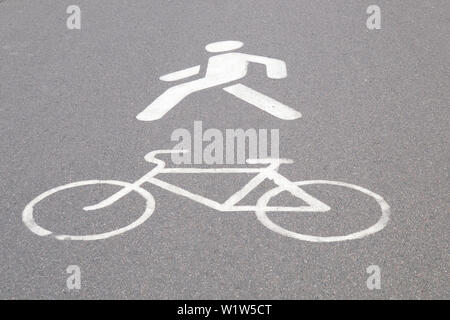 designation of a bicycle path and pedestrian walkway painted in white paint on asphalt Stock Photo