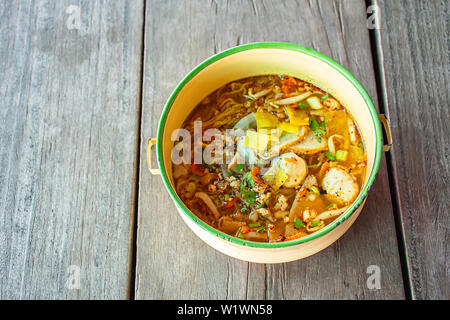 Spicy noodle soup with pork put the Pinto on wooden. Stock Photo