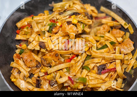 Bami Goreng is a pasta dish. Dish is made on a indonesian way with chicken brast and pasta. Stock Photo