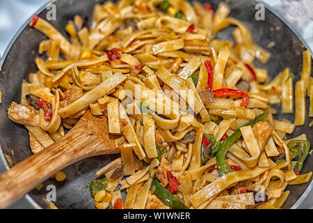 Bami Goreng is a pasta dish. Dish is made on a indonesian way with chicken brast and pasta. Stock Photo