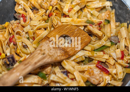 Bami Goreng is a pasta dish. Dish is made on a indonesian way with chicken brast and pasta. Stock Photo