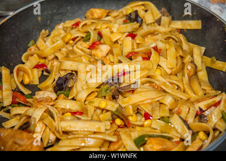 Bami Goreng is a pasta dish. Dish is made on a indonesian way with chicken brast and pasta. Stock Photo