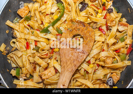 Bami Goreng is a pasta dish. Dish is made on a indonesian way with chicken brast and pasta. Stock Photo