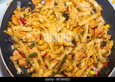 Bami Goreng is a pasta dish. Dish is made on a indonesian way with chicken brast and pasta. Stock Photo